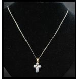 A hallmarked 18ct gold and diamond necklace strung with a white and yellow gold diamond set crucifix