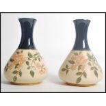 A pair of early 20th century Langley Mill stone wear vases having cobalt tapering necks with