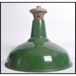 An early 20th century green and white two tone enamel painted metal factory pendant light. Space age