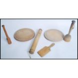 A collection of vintage 20th century Kitchenalia to include bread boards, butter paddles rolling pin