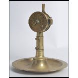 An unusual 20th century brass cigar cutter in the form of a ships telegraph / speed regulator raised