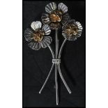 A large sterling silver brooch in the form of flowers having moving petals. Pin to verso. Weighs