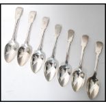 A set of seven early 19th century Georgian silver hallmarked table / dessert spoons in the fiddle