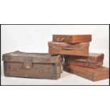 A stack of vintage suitcases from the 20th century to include a large leather example with