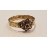 A Victorian 9ct gold vintage hallmarked ruby and seed pearl ladies flower head ring. The total