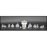 A group of fifteen Swarovski faceted glass crystal swans of varying form and sizes o include one