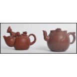 Two 20th century Oriental Chinese Yi-Zing teapots of novelty form. One having ant to lid and the