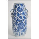 A 19th century blue and white ceramic vase having twin Chinese dragon handles with a hand painted