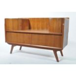 A retro 20th century teak wood side table dressing chest being raised on tapering legs with