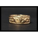 A hallmarked 9ct Gold Claddagh band ring inscribed  "with my two hands I give you my heart and