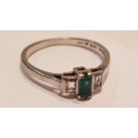 An 18ct gold and platinum 3 stone emerald and diamond ladies ring with baguette cut stones. Total