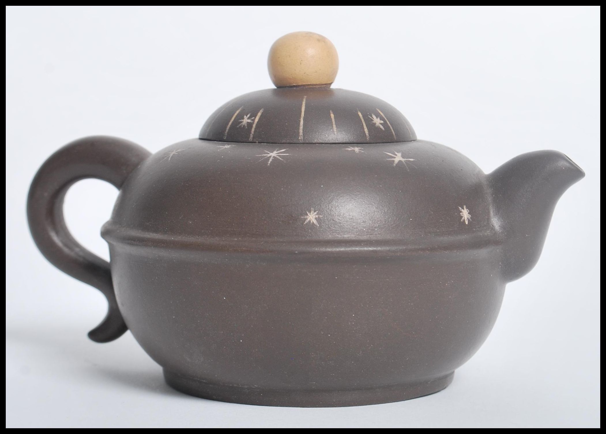 A Chinese Yi Zing terracotta teapot having a ball finial lid with star decoration and character