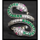 A sterling silver silver CZ and emerald adorned ring in the form of a coiled snake with ruby set