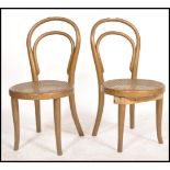 A pair of early 20th century Thonet bentwood childs chairs having rattan weave seat remnants of gilt