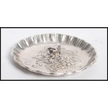 A vintage Spanish silver pin dish having a figurine of a bull to centre with pie crust edge. Spanish