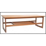 A retro 1970's teak wood rectangular coffee occasional table. Raised on tapering legs with