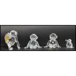 A group of Swarovski faceted glass monkey figurines to include two seated monkeys a monkey holding