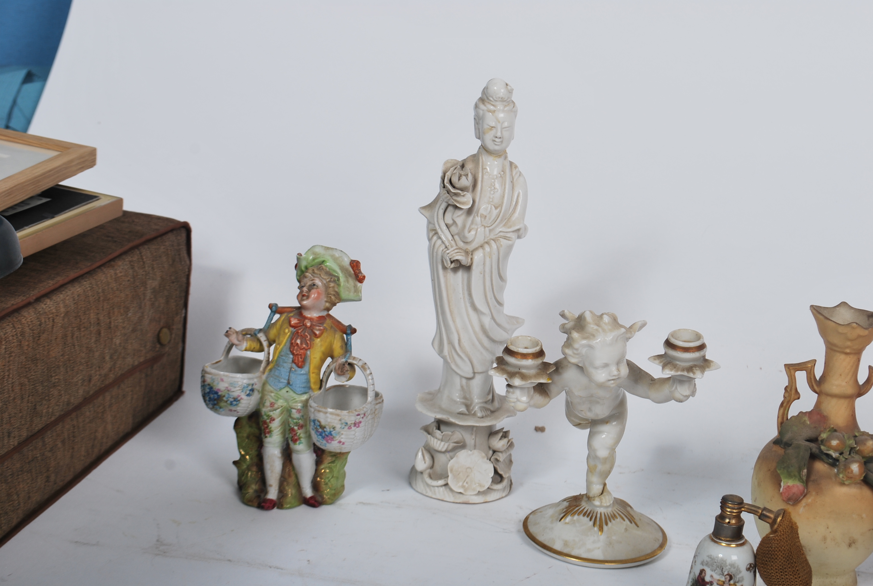 A Chinese blanc de chine figurine of a deity together with a German biscuit glaze cherub figurine - Image 6 of 9