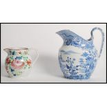 A mid 19th century pearlware blue and white castle pattern jug along with a floral pearl ware jug.