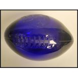 An unusual Dartington Blue glass Dallas Cowboys American football from Jerry Jones (owner of the