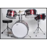 A vintage child's drum kit set in red and chrome along with a boxed Dennis the Menace musical