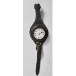 An Edwardian silver  pocket watch with early protective leather wrist strap. The silver fob watch