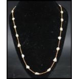 A 15ct gold and baroque pearl ladies Victorian necklace chain. The hoop linked chain interspersed