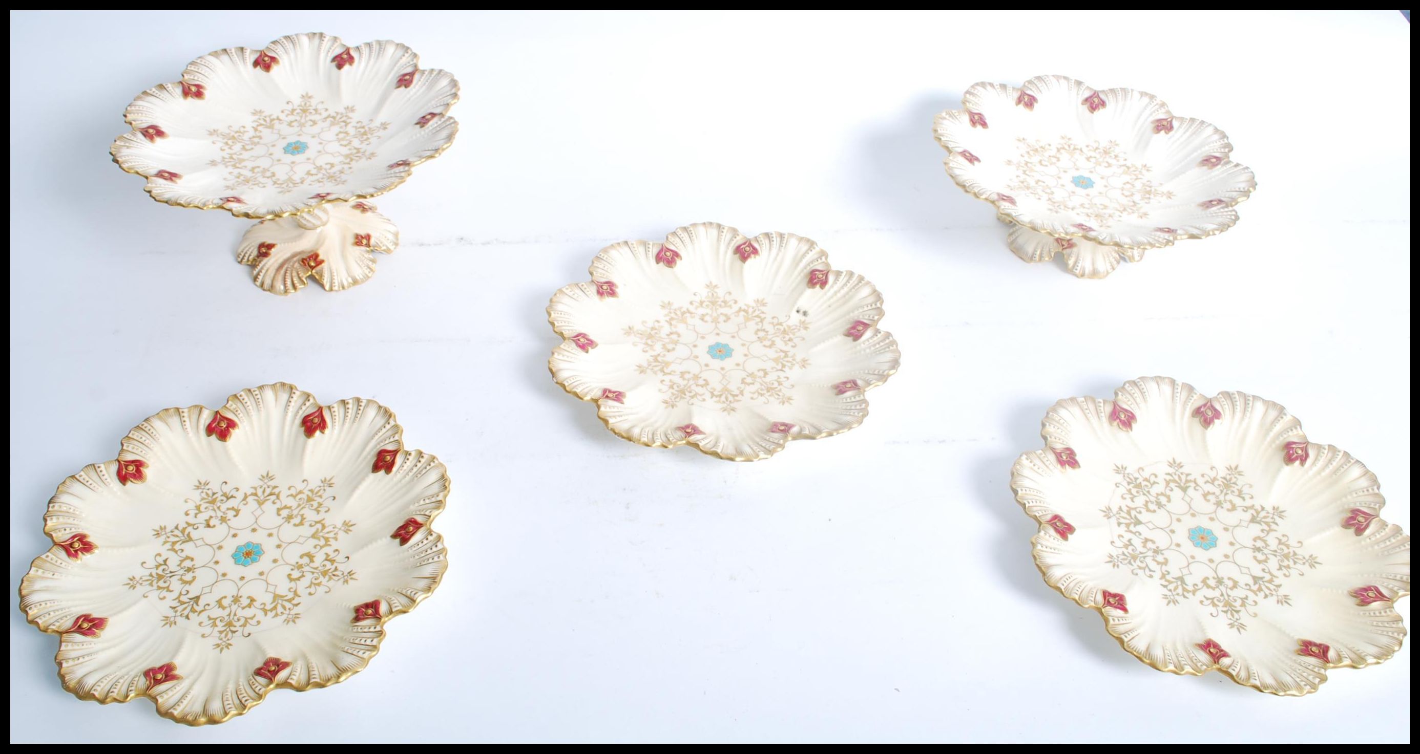 A 19th century Coalport ivory blush dessert set consisting of three plates and two tazzas / comports