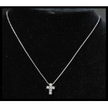 A hallmarked 18ct white gold and diamond pendant necklace strung with a white gold crucifix set with