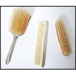 A three piece silver hallmarked art deco dressing table brush and comb set. Each piece being