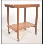 A retro 1970's Danish inspired teak wood butlers serving trolley raised on castors having squared