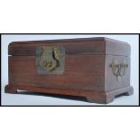 A Chinese mahogany jewellery casket having a carved medallion to lid with brass lock and fitted