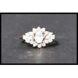 A hallmarked 9ct gold and CZ cluster ring . Hallmarked Birmingham . Weight 2.8g  . Size  L.