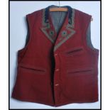 An unusual 20th century embroidered waistcoat made from red velvet with embellished braided