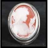 A sterling silver dress ring having a cameo of a maiden holding a dove. Weighs 8.5 grams.