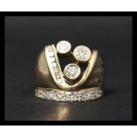 An unusual 9ct gold and diamond ring with illusion, channel and bezel set diamonds in the