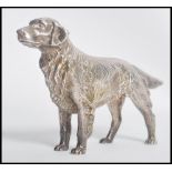 A vintage silver plated figurine of a retriever dog  modelled in a standing position. Measures