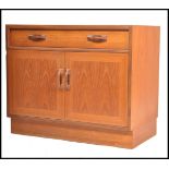 A retro 1970's G-Plan teak wood cabinet  / cupboard. Raised on a plinth base with twin door cupboard