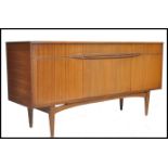 A retro 20th century teak wood effect sideboard having a run of three drawers to the top with a