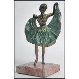 A 20th century cold painted bronze figurine of a dancing Art Deco flapper girl raised on a square