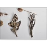 A collection of silver and gold ( untested ) brooches and tie pins / clips to include silver