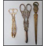 A gilt silver hallmarked pair of ornate sugar nips / tongs along with a pair of 19th century