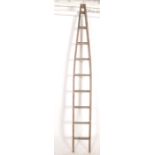 A 20th century vintage solid pine painted industrial fruit pickers ladder of tapering form with