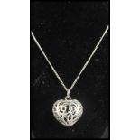 A sterling silver heart shaped pendant set to a sterling silver curb link chain. Measures 16