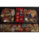 A vintage jewellery box containing brooches , rings, decanter label , Russian brooch etc. Please see