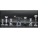 A group of seven Swarovski cut glass crystal candlesticks of tall from to include two floral