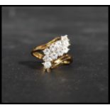 A 14ct gold ring of crossover form having rows of white stones. Weighs 3.5 grams.