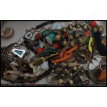 A collection of vintage assorted costume jewellery stored within a floral fabric covered jewellery