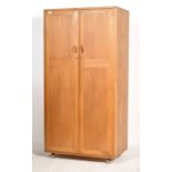 A stunning 20th century light beech and elm wood Ercol two door ' Windsor pattern ' wardrobe, fitted