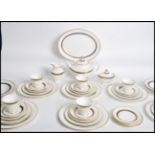 A Royal Doulton ' Harrow ' pattern part table service comprising plates of varying sizes, bowls,